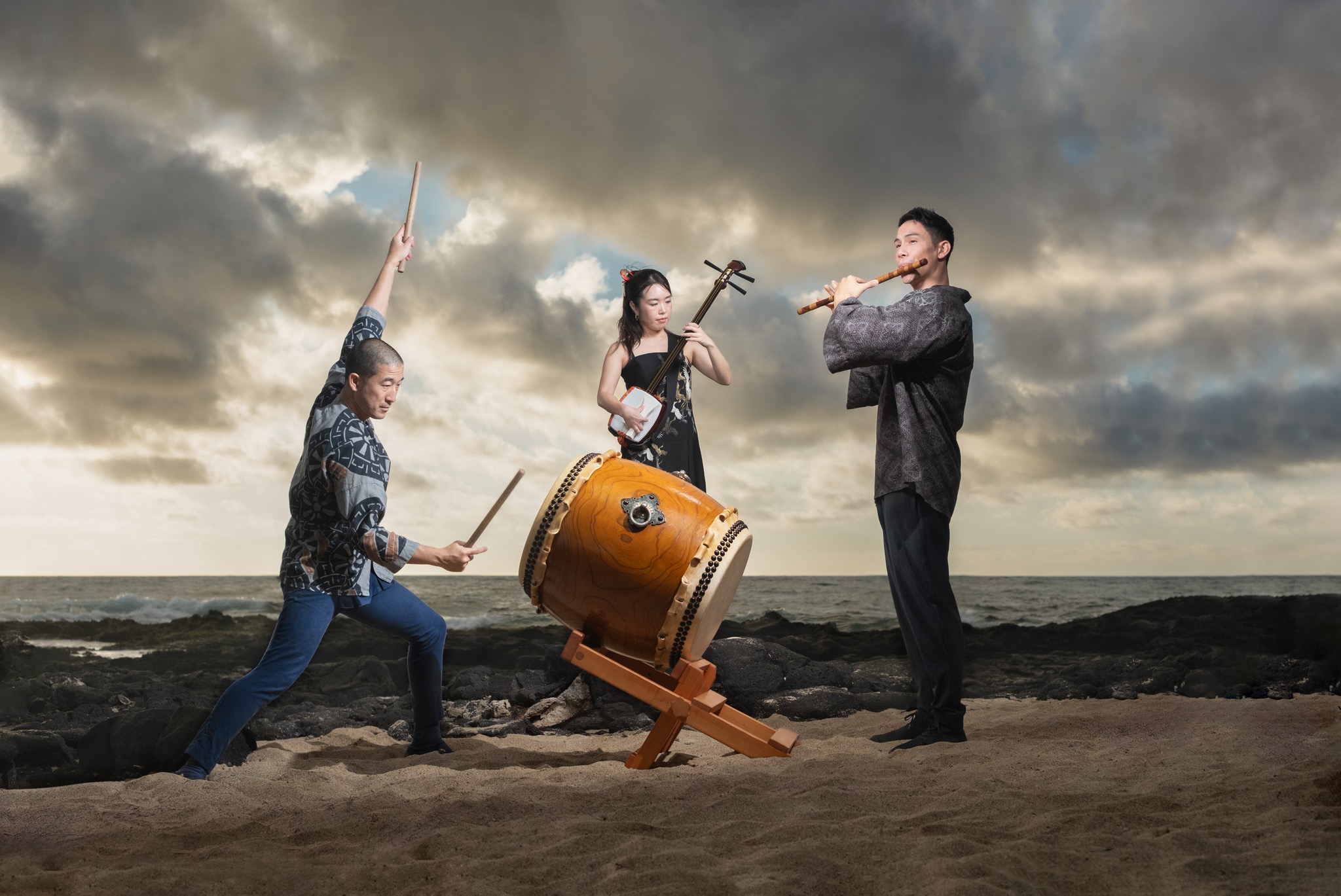MikAnS performing with taiko and shinobue on the shoreline
